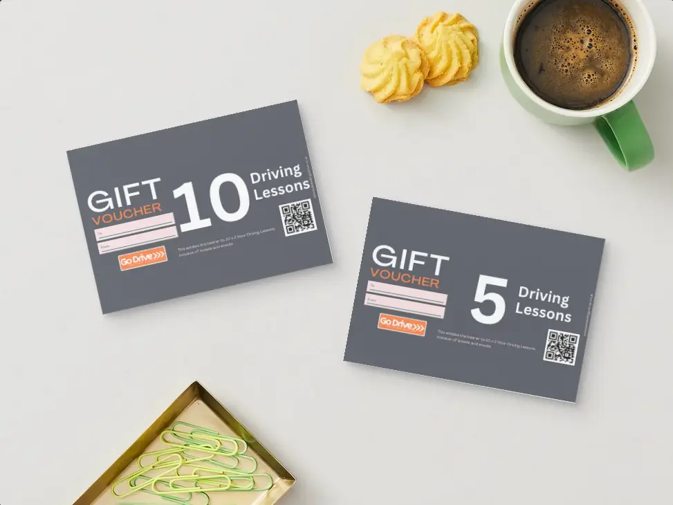 Driving Lesson Gift Voucher with a card and envelope, Image showing gift vouchers which are available and make the perfect Christmas or Birthday Gift allowing the recipient to use them for booking driving lessons in Essex including cities such as Southend, Chelmsford as well as towns such as Leigh on Sea, Rayleigh, Basildon